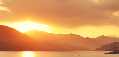 calm evening landscape with lake and mountains