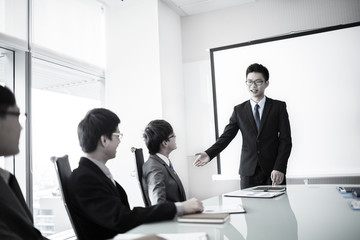 businessman giving a presentation to his colleagues
