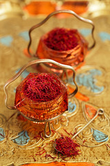 saffron spice in antique vintage glass bowl, closeup