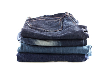 Many jeans stacked isolated  on a white background