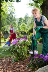 Fototapeta na wymiar Woman with spade in garden