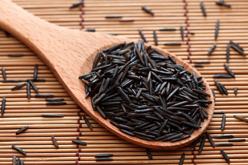Wild rice in a wooden spoon