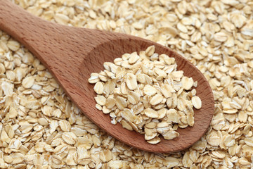 Rolled oats in a wooden spoon