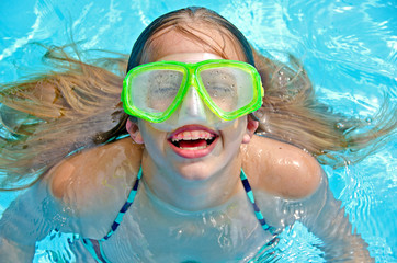 young girl with swim goggles