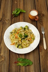Stewed cabbage with broccoli, chard leaves on a white plate