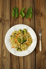 Stewed cabbage with broccoli and chard leaves on a white plate