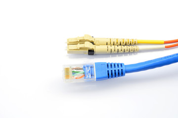 Close up of a fiber optic patchcord head and UTP LAN cable head