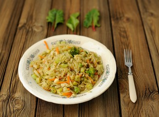 Stewed cabbage with broccoli and chard leaves on a white plate