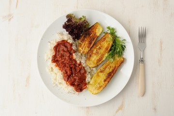 Fried zucchini with rice and sause