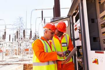 two electrical engineers using laptop computer