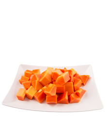 Bite sized papaya fruit on white plate over white background