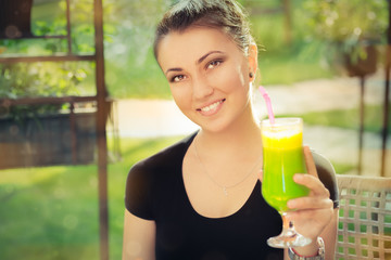 Young Woman with Colorful Cocktail Drink Outside