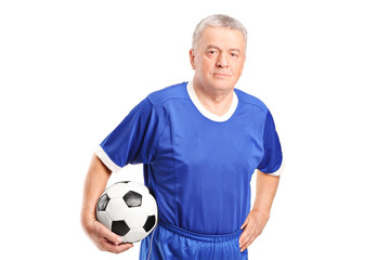 Mature man in sportswear holding a football
