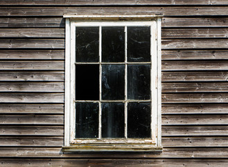 Old window with a curtain of the wooden house