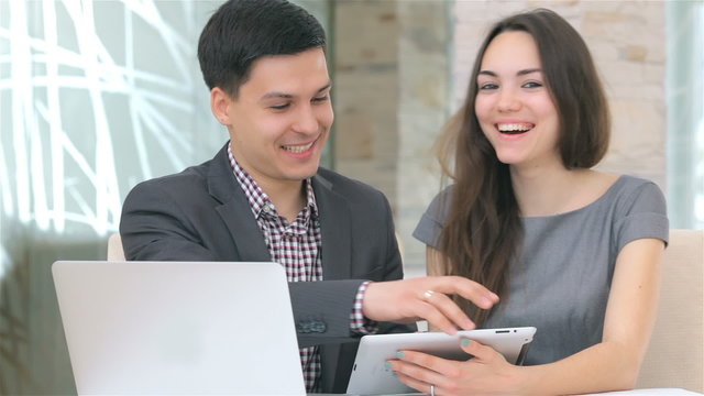 young attractive business man and woman discussing collating dat