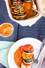 vegetable ratatouille on a plate with sauce, top view