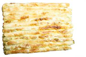 Homemade pie set in lines filled with cheese and spinach