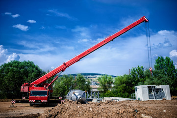 Industrial Crane operating and lifting an electric generator