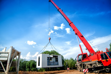 big, industrial crane moving a mobile cement plant