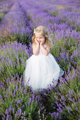 Fototapeta na wymiar Smiling toddler girl in lavender
