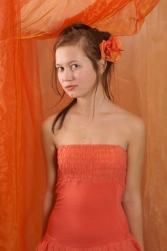 Teenager, girl in orange dress and flower in her hair
