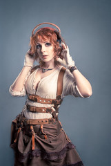 Beautiful redhair woman listening to music with headphones