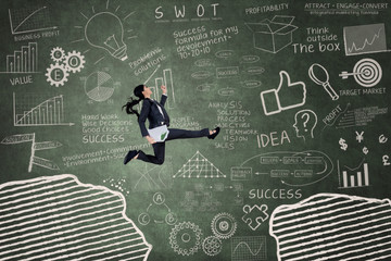 Business woman leaping over a gap