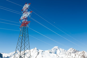 High voltage power lines in winter mountain landscape