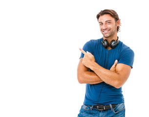 Smiling young man pointing copy space