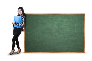 Student and empty blackboard