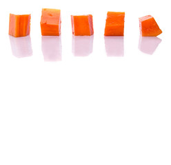 Bite sized papaya fruit over white background