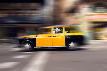 Fototapeta na wymiar Yellow and Black Taxi - Barcelona Spain