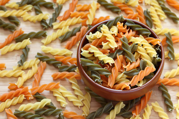 Raw colorful fusilli pasta in a bowl