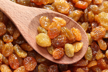 Raisins in a wooden spoon