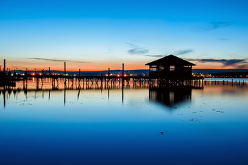 Fototapeta na wymiar Night lake view with old fisherman cottage