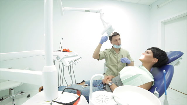 Dentist includes a lighting fixture before dental treatment