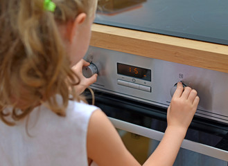 Fototapeta na wymiar Child playing with electric oven.