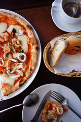 Top view of slice of pizza in plate on a restaurant table