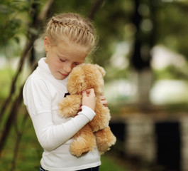sad girl with teddy bear