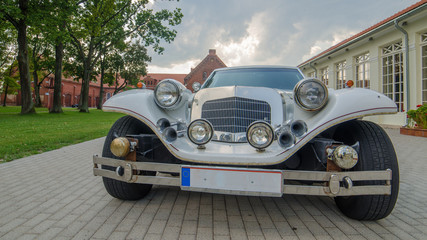 Vintage limousine next to castle in Raudondvaris, Lithuania