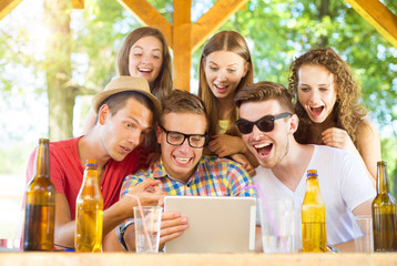 Friends drinking and using tablet