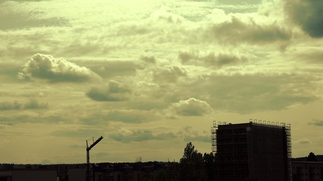 Silhouette of an evening city with thunderclouds, timelapse
