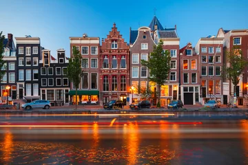 Gordijnen Night city view of Amsterdam canal with dutch houses © Kavalenkava