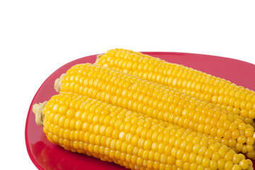 Cooked corns on red plate