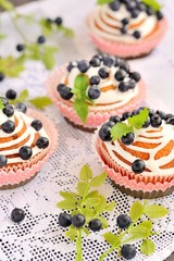 homemade cupcakes with icing and blueberries