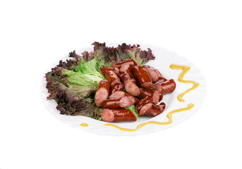 Close up of sausage salad with lettuce leaves.