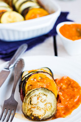 vegetable ratatouille in a round plate with sauce, vertically