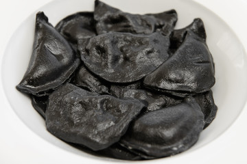 black dumplings on a plate