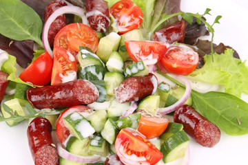 Fresh salad with sausage.