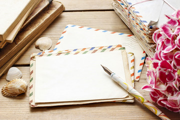 Vintage letters, books and bouquet of pink hortensia flowers